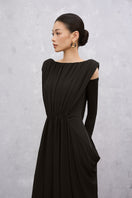 Black VELA maxi dress by EEGEN STUDIO, featuring flowing fabric and elegant design, shown on a model.