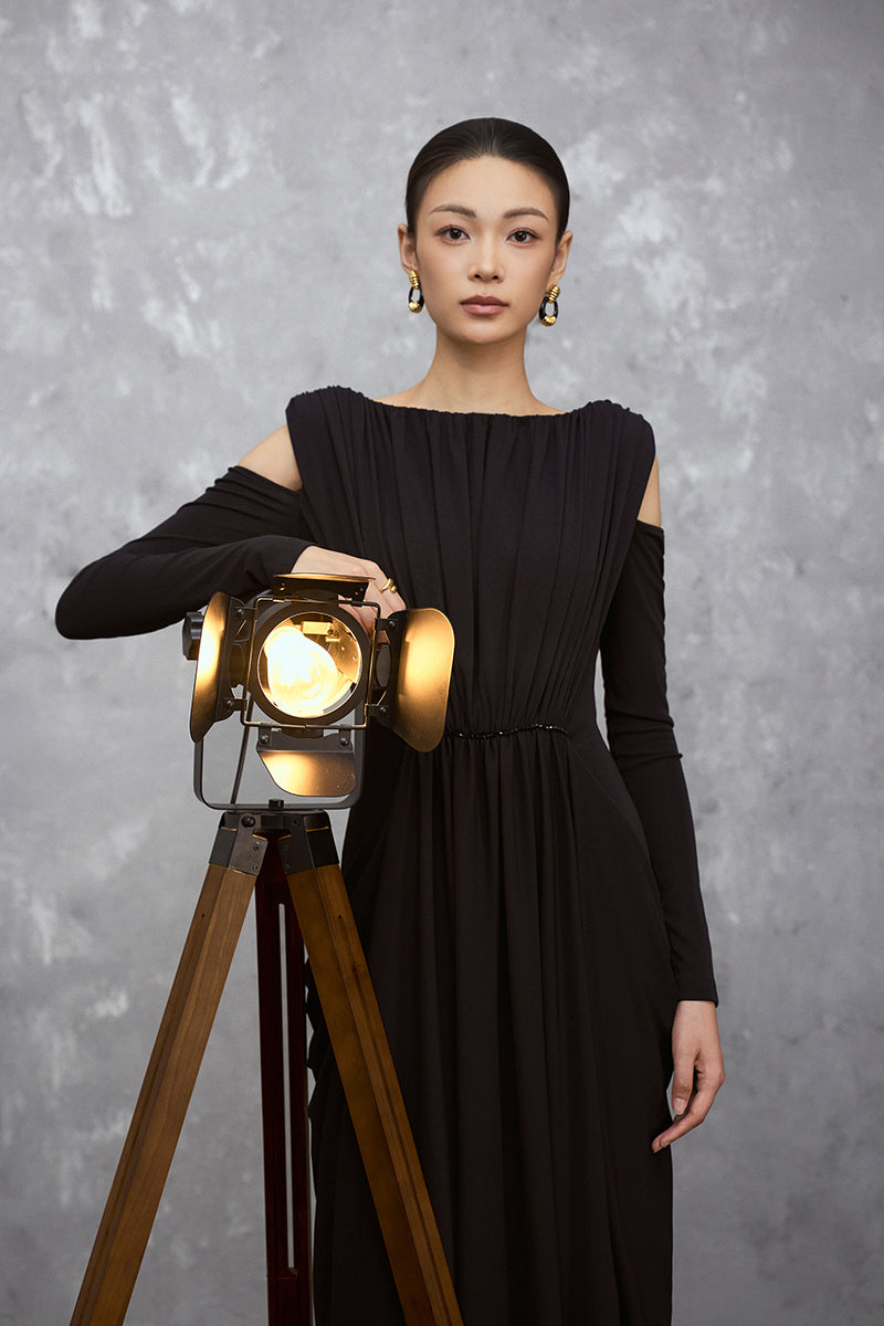 Black VELA DRESS maxi dress by EEGEN STUDIO, featuring flowing fabric and elegant design, displayed on a model.