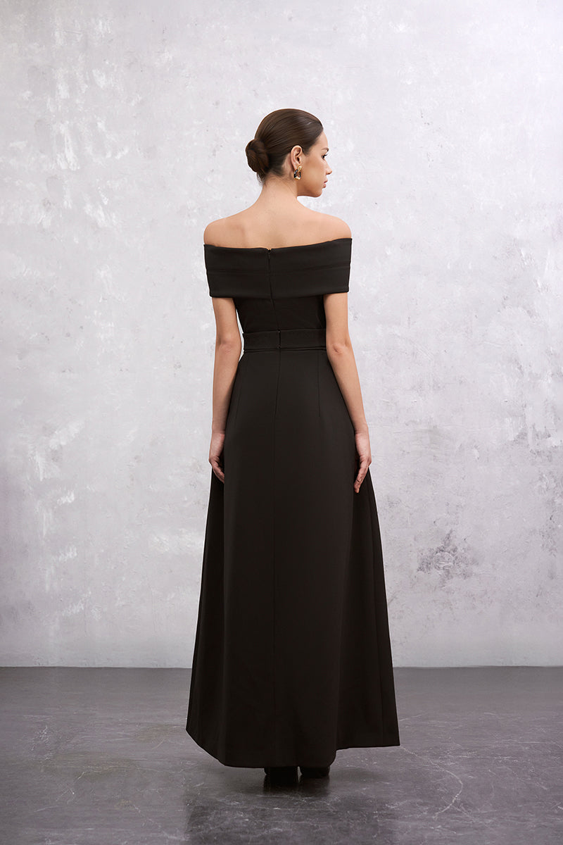 Black EEGEN STUDIO Clara maxi dress displayed on a hanger with flowing fabric and elegant design.
