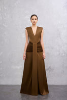 Brown AIRA gown by EEGEN STUDIO, elegant dress with flowing fabric and intricate design, shown on a dress form.