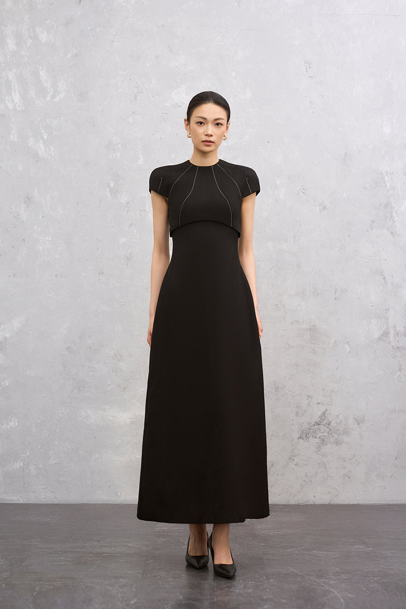 Black Lyra Maxi Dress by EEGEN STUDIO featuring a flowy silhouette and elegant design, shown on a model.