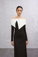 Elegant black and white DARELLA gown by EEGEN STUDIO, showcased on a dress form with flowing fabric and detailed design.