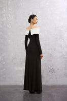 Elegant black and white Darella gown by EEGEN STUDIO featuring flowing fabric and intricate design details.