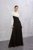 Elegant black and white Caelis gown by EEGEN STUDIO, featuring flowing fabric and stylish design, perfect for formal occasions.
