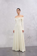 White Elowen maxi dress by Eegen Studio, flowing fabric with a relaxed fit, showcased on a model.