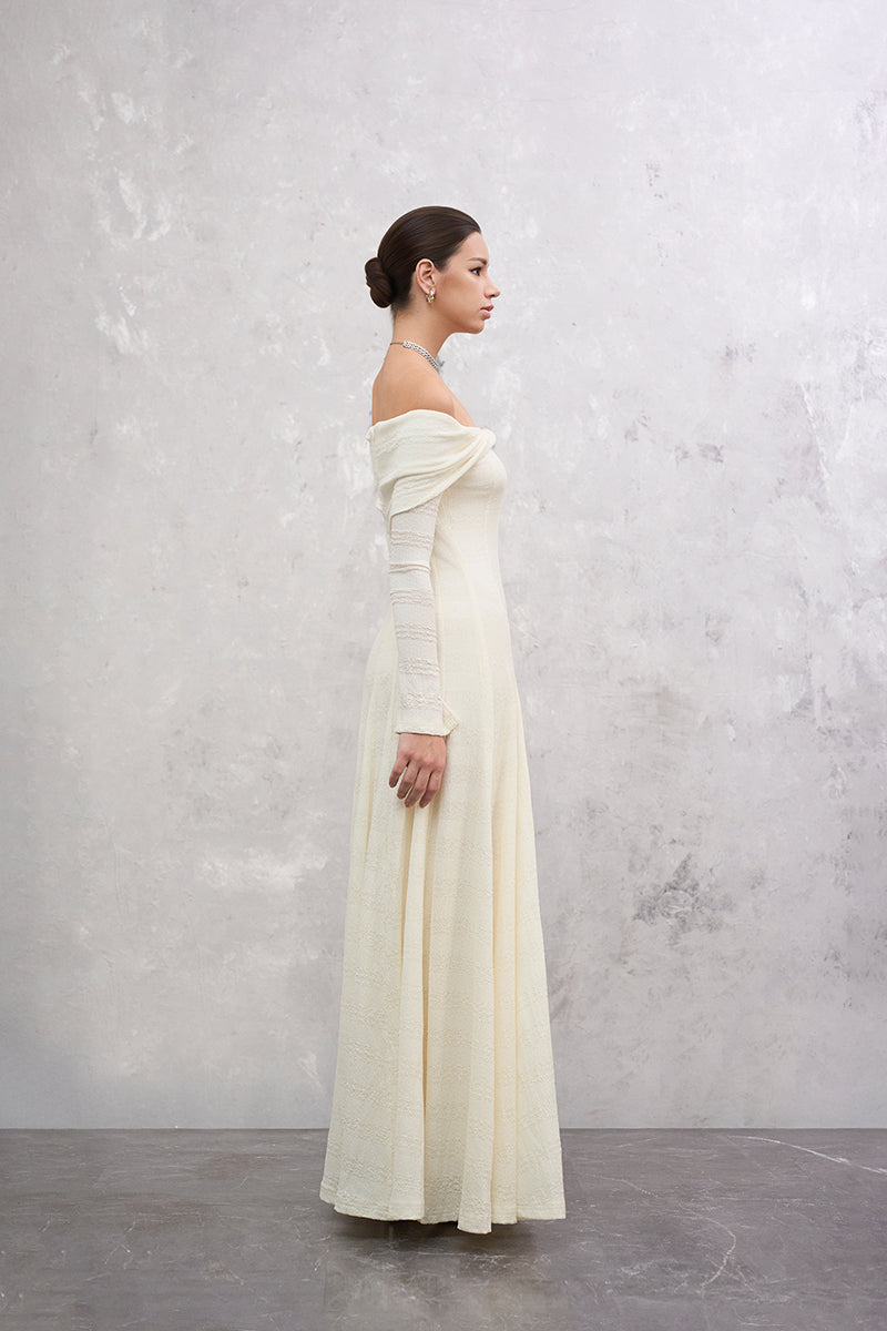 ELOWEN white maxi dress by EEGEN STUDIO displayed on a hanger, featuring flowing fabric and elegant design.