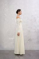 White Elowen maxi dress by EEGEN STUDIO, flowing fabric and elegant design, shown on a model in a full-length shot.