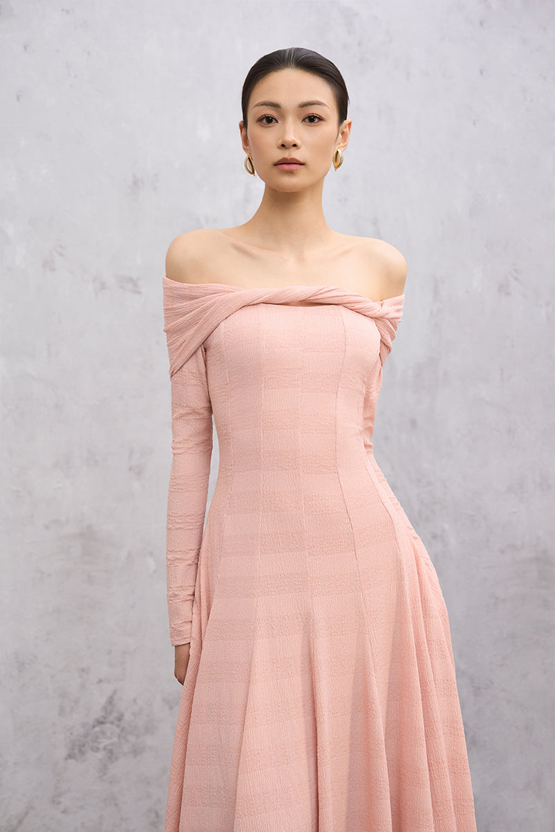 Pink Elowen maxi dress by EEGEN STUDIO, flowing fabric with a fitted bodice and elegant design, displayed on a hanger.