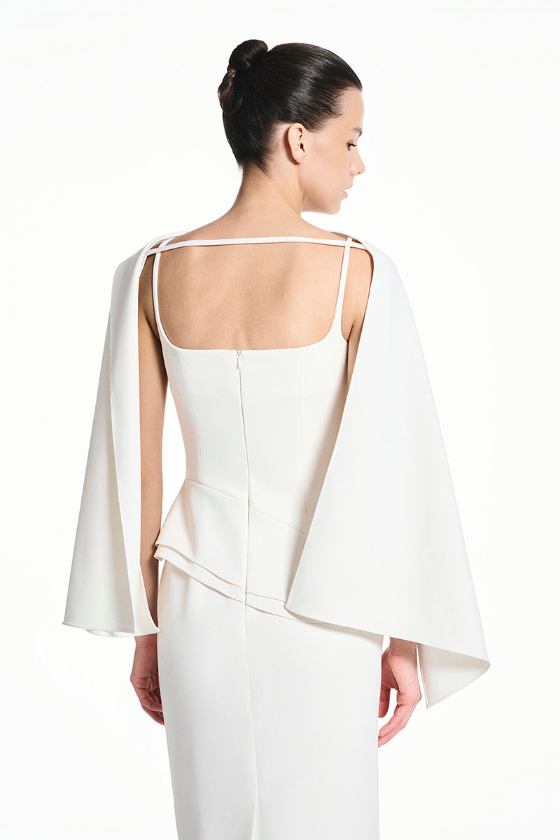 White spandex maxi dress by EEGEN STUDIO, featuring a fitted silhouette and flowing design, shown on a model.
