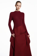 Red spandex jersey gown by EEGEN STUDIO featuring a sleek, form-fitting design and elegant drape for a stylish look.