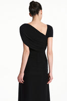 Black spandex knit maxi dress by EEGEN STUDIO featuring a fitted silhouette and long sleeves, displayed on a mannequin.