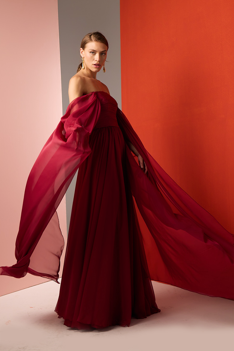 Red strapless gown by Joanna Andraos featuring a flowing, elegant design perfect for formal occasions.