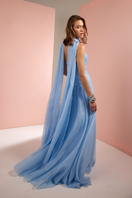 Baby blue strapless gown with matching scarf by Joanna Andraos, featuring elegant fabric and a flowing silhouette.