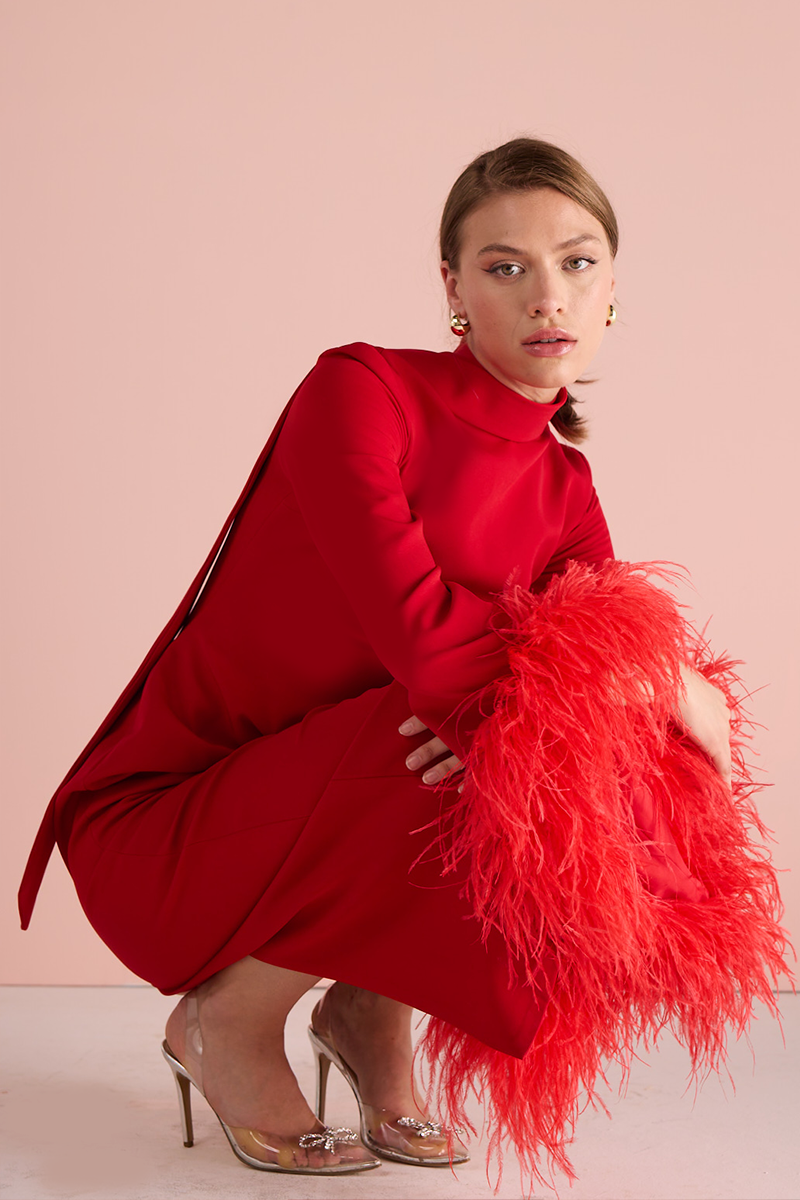 Red Joanna Andraos halter neck midi dress displayed on a model with a fitted waist and elegant flowy skirt.