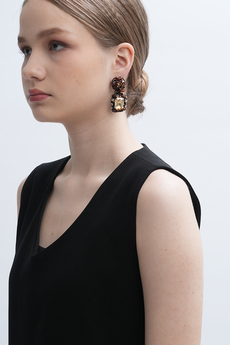 Gold Amora earrings by Aidan & Ice featuring elegant gold hoop design with intricate detailing, displayed on a neutral background.