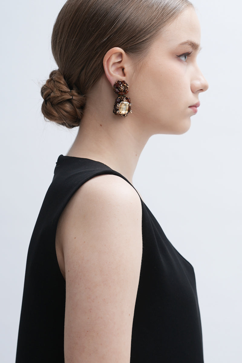 A pair of gold Amora earrings by Aidan & Ice, featuring elegant design and shiny gold finish, displayed on a white background.