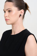 Aidan & Ice Golden Flow Earrings featuring sleek, curved gold design on a white background.