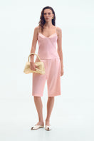 Pink satin wide-leg shorts by ELENAREVA, featuring smooth fabric and relaxed fit, displayed on a neutral background.