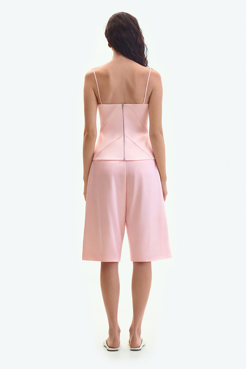 Pink satin wide-leg shorts by ELENAREVA, featuring a smooth fabric and relaxed fit, shown on a neutral background.
