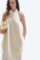 Cream silk open-back blouse by ELENAREVA, featuring a stylish design with a smooth silk fabric and elegant open back detail.