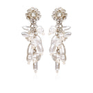 A pair of white Aidan & Ice Neilla earrings with a sleek, minimalist design hanging against a neutral background.
