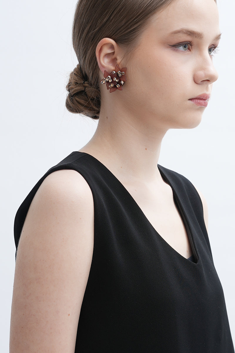 A pair of Peach Greta earrings by Aidan & Ice featuring elegant peach-colored dangle earrings with gold accents.