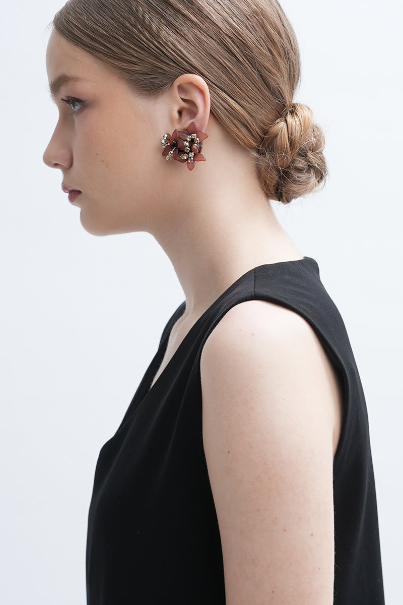 Aidan & Ice Peach Greta earrings featuring vibrant peach-colored earrings with gold accents, hanging from delicate hooks.
