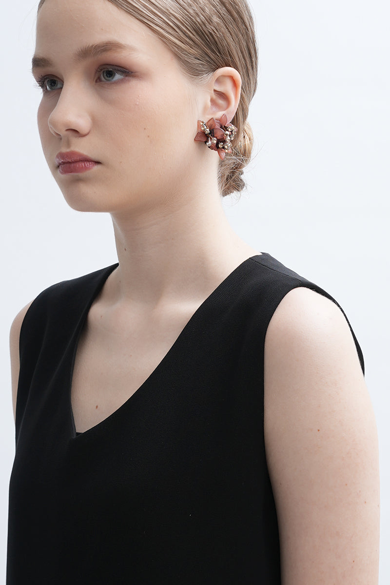 A pair of Peach Greta earrings by Aidan & Ice featuring peach-colored hoops with gold accents on a white background.