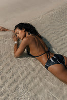 Nelblu Morpho Top black bikini, stylish swimwear with supportive design, shown on a model.