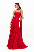 Red Estrella gown by Moon Hakaan Yildirim, elegant floor-length dress with flowing fabric and intricate detailing.