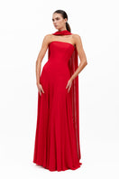 Red Estrella gown by Moon Hakaan Yildirim featuring elegant fabric and a flowing silhouette.