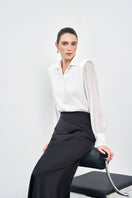 Black silk midi skirt by EEGEN STUDIO, featuring a smooth, flowing fabric and elegant midi length.