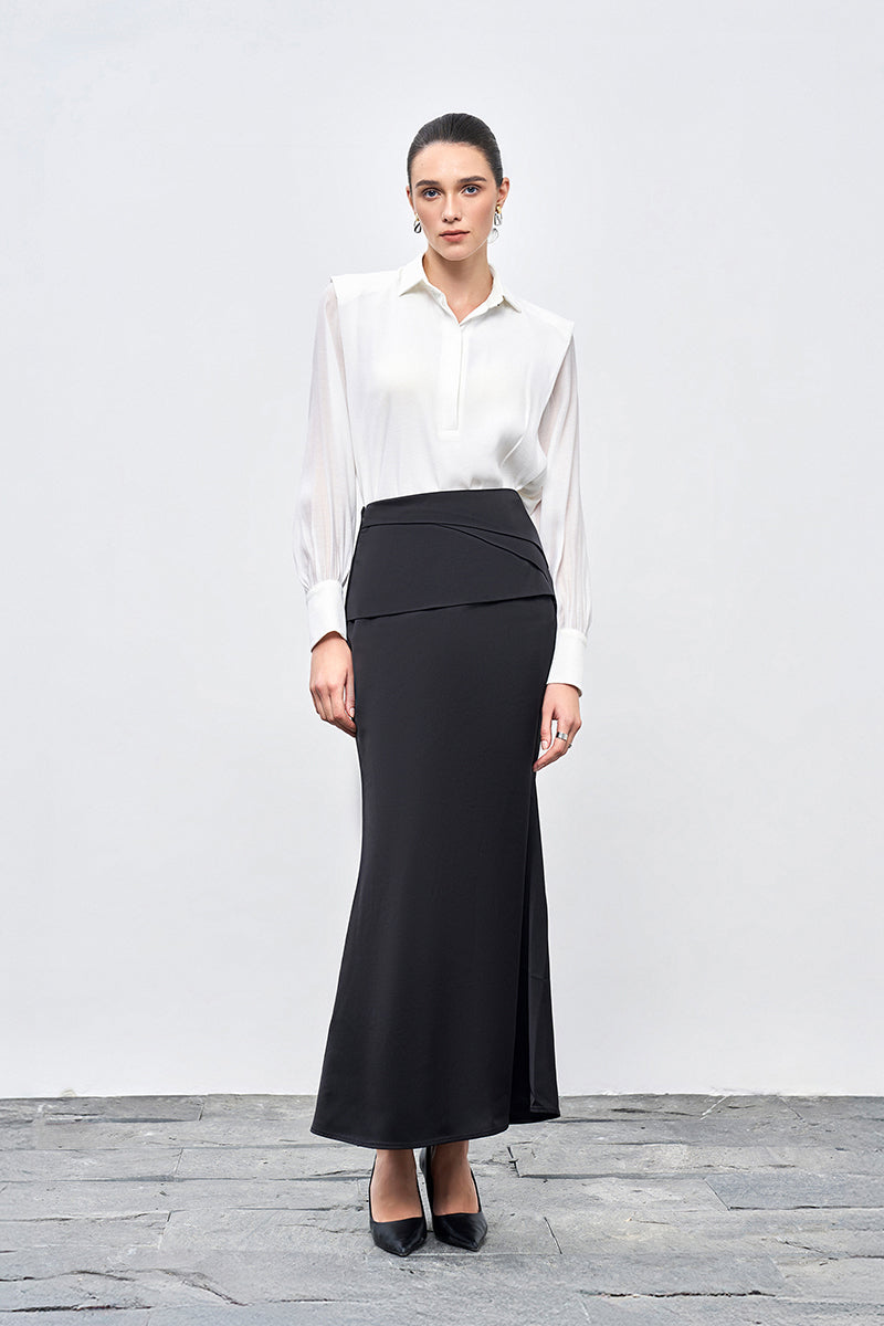 Black silk midi skirt by EEGEN STUDIO with a smooth, flowing fabric and elegant design, shown on a model.