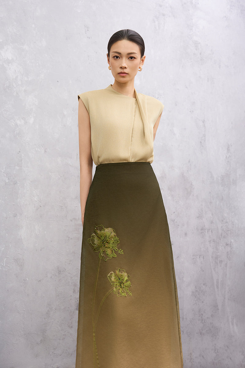 EEGEN STUDIO Senna midi skirt in moss green, flowing fabric with a stylish waistband, shown on a model.
