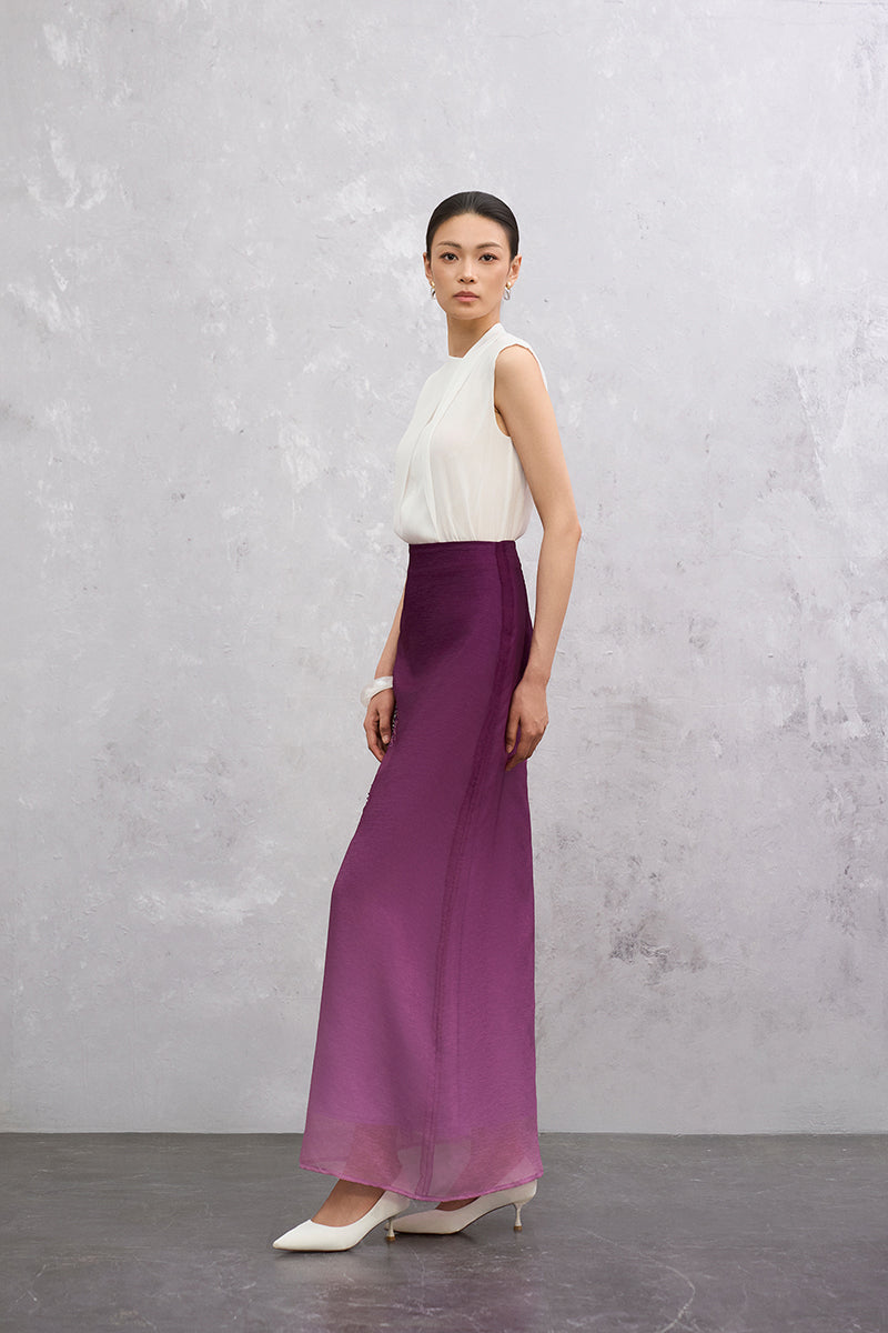 Purple Senna midi skirt by EEGEN STUDIO, showing flowing fabric and stylish design on a flat lay.