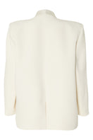Studio NK ETHERAL blazer in ivory, stylish tailored blazer with a sleek fit, displayed on a model with a plain background.