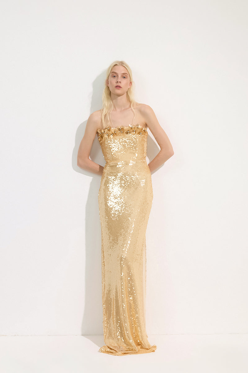 Gold URBAN MUSE Etoile gown featuring a flowing maxi dress design with elegant fabric and detailed craftsmanship.