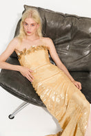 Gold ETOILE gown by URBAN MUSE featuring a flowing maxi dress with elegant drape and intricate detailing.