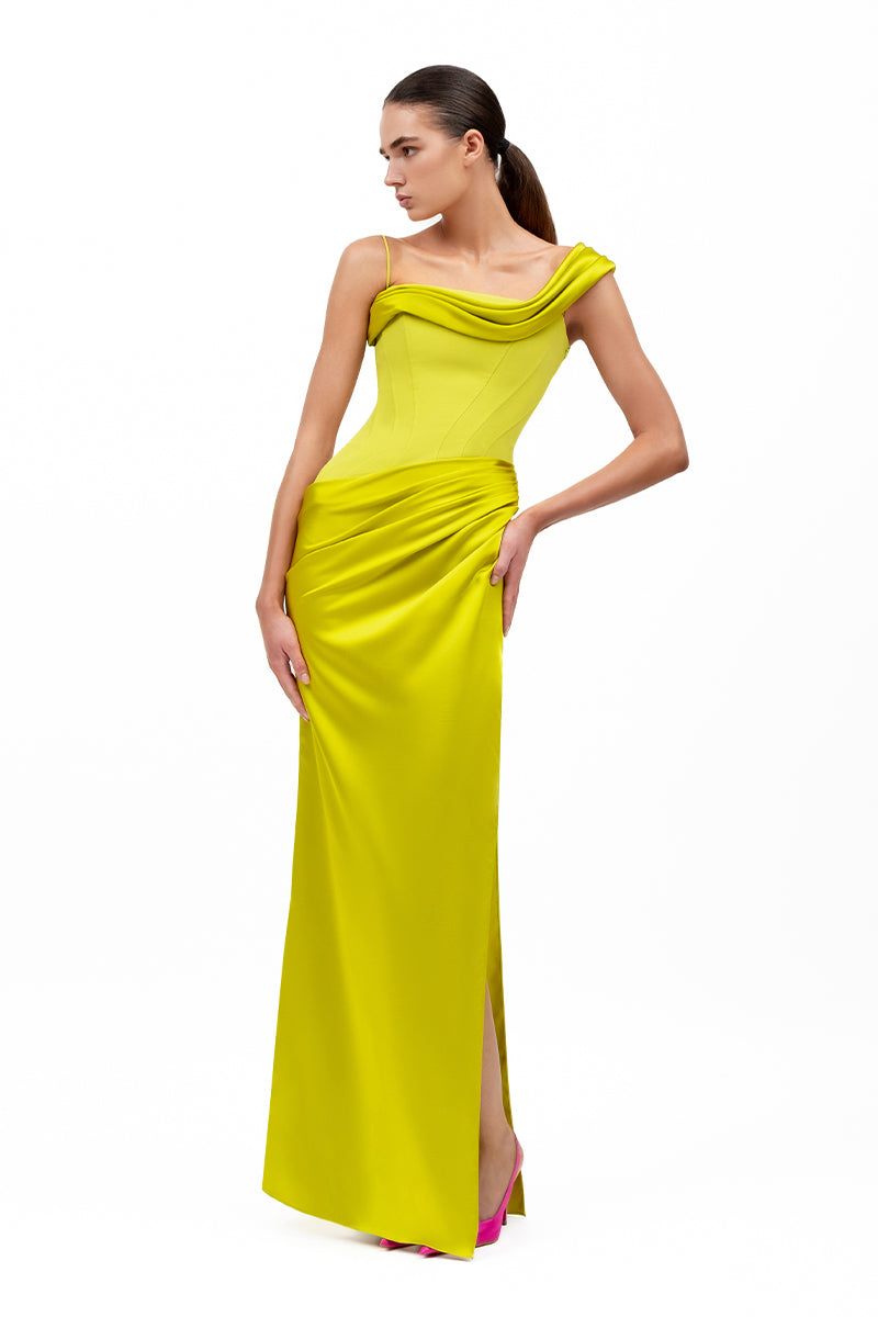 Elegant pistachio ÈTOILE gown by MOON / HAKAN YILDIRIM, showcasing flowing fabric and sophisticated design.