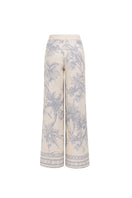 White printed EZMIR pants by Tinta Latina, stylish casual pants with vibrant design, shown laid flat on a white background.