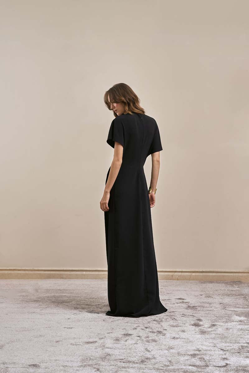 Back view of YASSMIN SALEH black maxi dress from the EASE DRESS collection, featuring a flowing silhouette and elegant design.