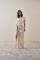 YASSMIN SALEH ivory maxi dress with a flowing design, front view showcasing elegant fabric and relaxed fit.