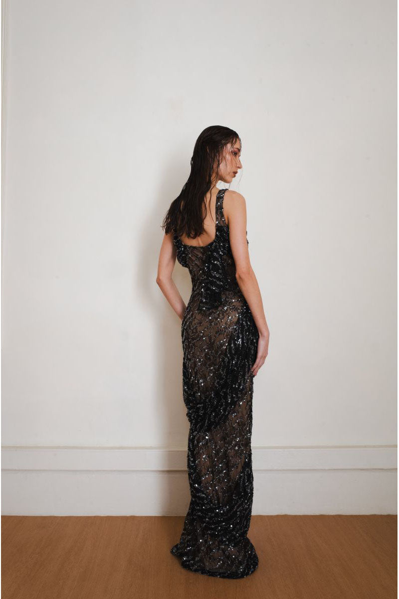 Black Echo gown by Yassmin Saleh, elegant long gown with a flowing design, shown from the back.