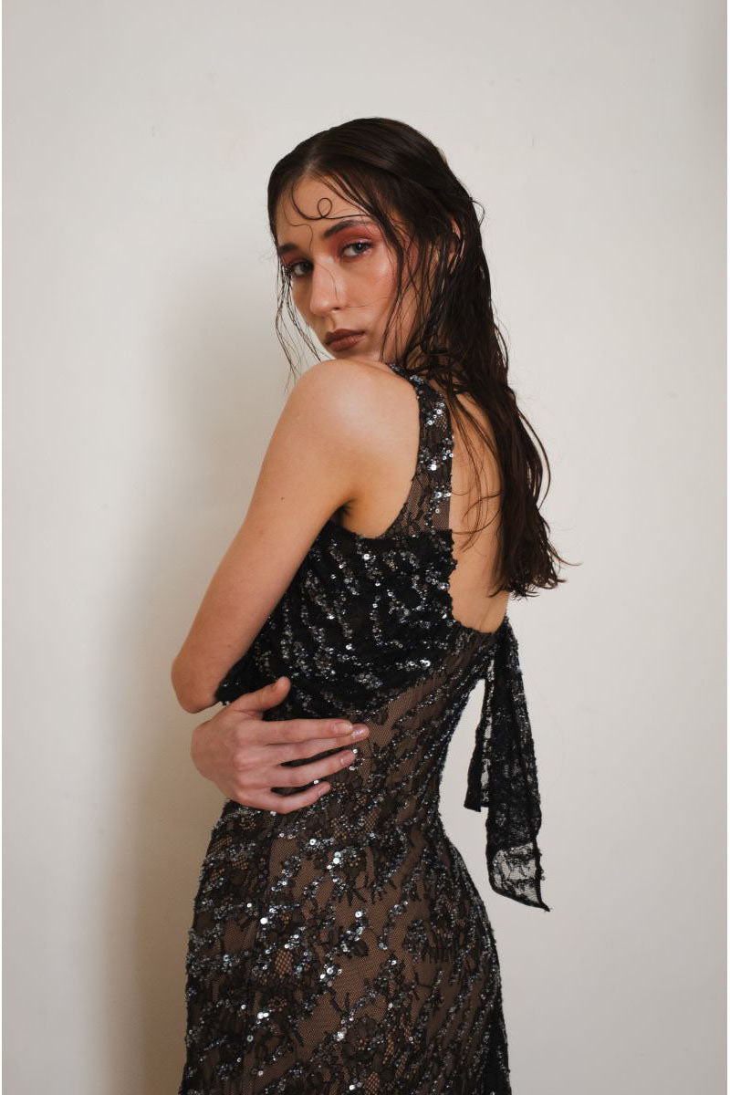 Close-up of YASSMIN SALEH black Echo gown showing elegant fabric and detailed design.