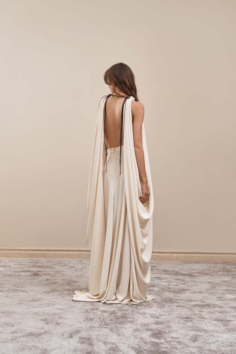 Ivory Eclipse Gown maxi dress by YASSMIN SALEH, back view showing flowing fabric and elegant design.