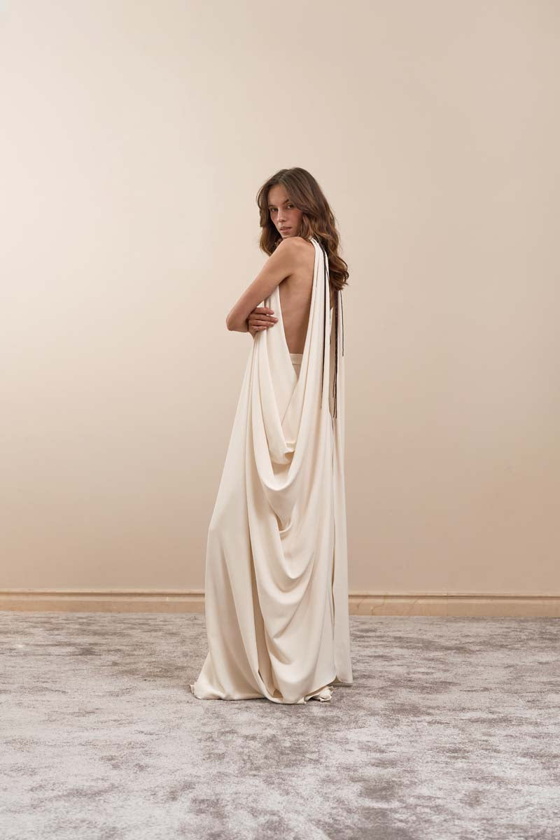 Ivory Eclipse Gown by Yassmin Saleh, elegant maxi dress with flowing fabric and side view showcasing its stylish silhouette.