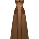 Elegant AIRA dress gown by EEGEN STUDIO, featuring flowing fabric and intricate details, showcased in a stylish fashion photograph.