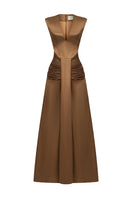 Elegant AIRA dress gown by EEGEN STUDIO, featuring flowing fabric and intricate details, showcased in a stylish fashion photograph.