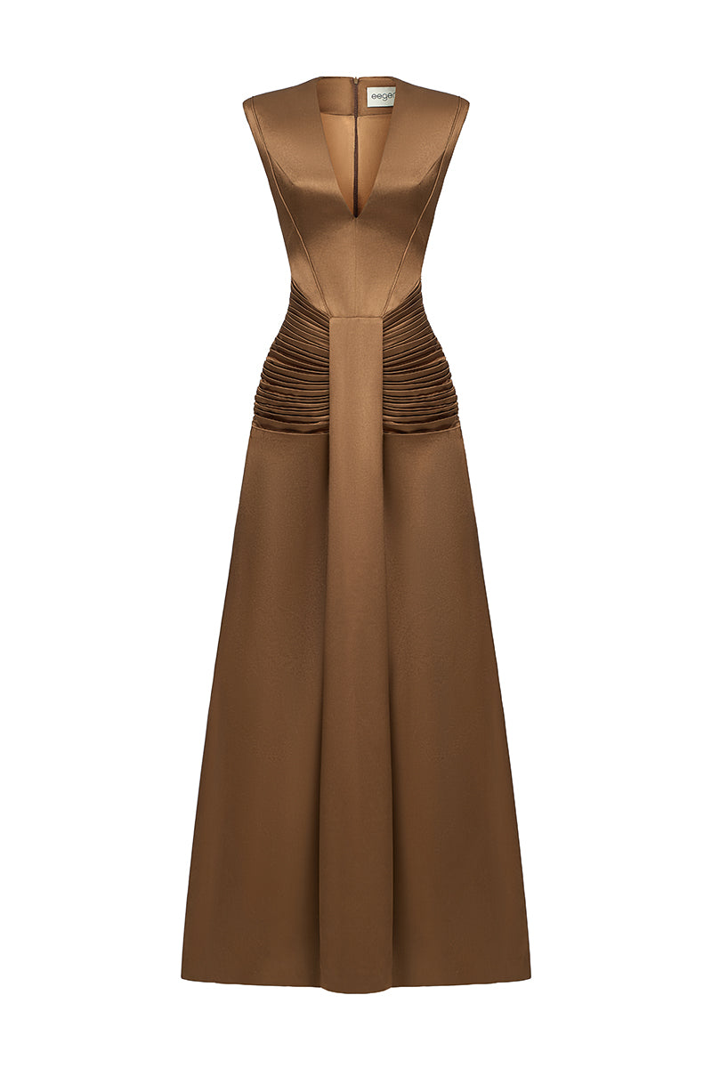 Elegant AIRA dress gown by EEGEN STUDIO, featuring flowing fabric and intricate details, showcased in a stylish fashion photograph.