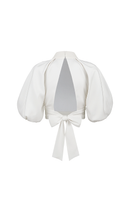 Light ivory Elara crop top by ANA + MARIA, shown on a ghost mannequin, highlighting its fitted design and soft fabric.